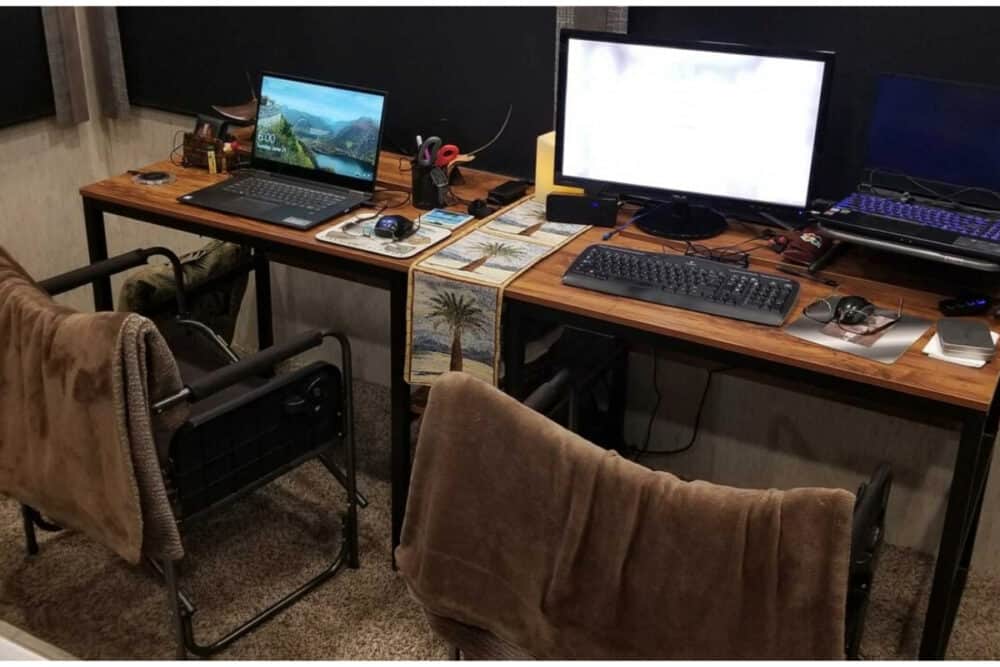 full desk with chairs and computer  set up against sidewall of RV--completed DIY RV office