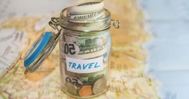 full-time RVing money savings in a glass jar on a map