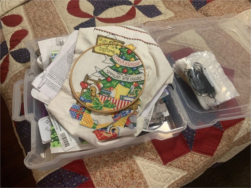 colorful cross stitching project in plastic container