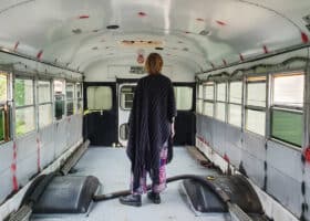person inside an empty bus, ready to convert