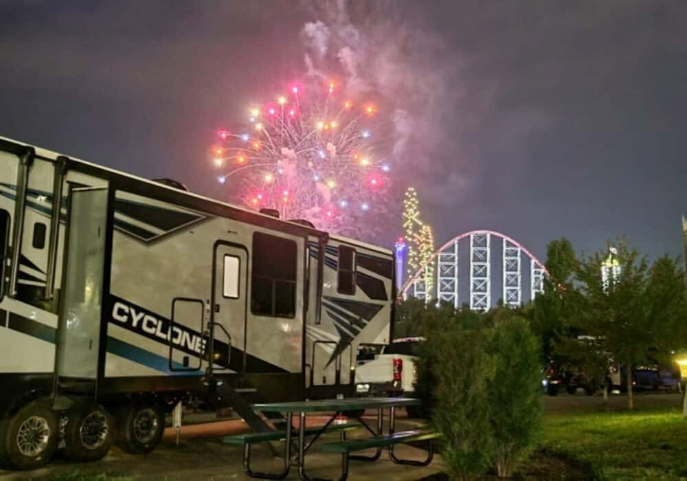 RV parked at World of Fun Village RV Park with fireworks and a rollar coaster in the background and near by a major league baeball stadium